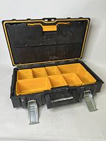 Front view of DeWalt TOUGHSYSTEMS toolbox open showing 8 yellow storage cups fitted inside the main compartment and silver metal latches on front.