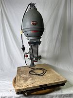 Full side view of the Hansa photographic enlarger on wooden base with electric cord visible.