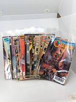 Stack of approximately 15 comics in protective sleeves, showing the front covers including Conan and others.