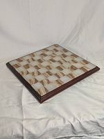Full view of the marble chess board angled to show the entire surface and rosewood frame.