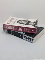 Two paperback books stacked, both about Neil Young with visible spine wear.