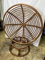 Full view of papasan chair frame showing circular seat and backrest made from concentric bamboo rings and connected bamboo supports. Base is circular cane and bamboo ring pedestal.