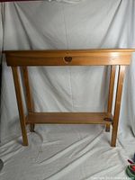 Full view of the pine sideboard showing the overall shape and design with the heart cutout on the front.