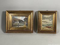 Two small framed oil paintings displayed side-by-side showing overall condition