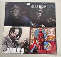 Four Miles Davis vinyl albums laid out flat
