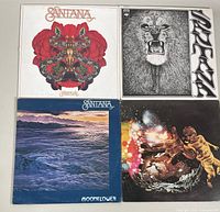 Four vintage Santana vinyl record albums visible, showing artwork and condition.