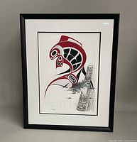 Front view of the framed indigenous styled painting featuring salmon and totem pole motifs in red, black, and white ink and paint.
