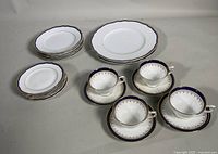 Photo showing 4 AYNSLEY teacups with 3 saucers and stacks of Franconia Krautheim 'La Marquise' luncheon and dinner plates