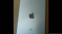 Back of silver Apple iPad Mini showing Apple logo and model details