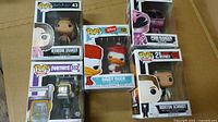Front view of 5 Pop Funko collectible boxes stacked together showing Hermione Granger, Daisy Duck, Pink Ranger, Morton Schmidt, and Fortnite figure.
