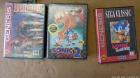 Front view of three Sega Genesis game cases Risk, Sonic 2, and Sega Classic Sonic the Hedgehog