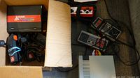 Box with Atari Flashback console, 3 controllers, and cables packed inside