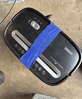 Top view of black Cross Cut Pro shredder showing control switch, paper slot, and warning icons.