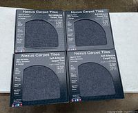 Four packs of Nexus Carpet Tiles with self-adhesive backing, shown in unopened packaging.