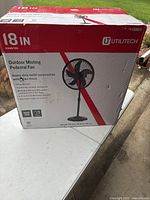 Box showing Utilitech 18 inch outdoor misting pedestal fan with details about construction, features, and adjustable height