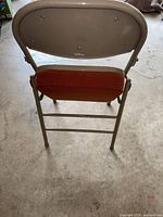 Back view of vintage Krueger folding chair showing metal back with Krueger logo.