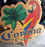 Wooden Corona Extra sign featuring a colorful parrot and palm trees on wood, vintage style.