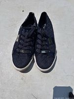 Front view of pair of Guess women's black quilted fabric shoes, size 10M.