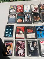 Photo showing first set of 15 cassette tapes with album covers including Queen, Meat Loaf, Run DMC and others.