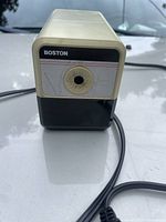 Front view of Boston electric pencil sharpener showing pencil insertion hole and branding.