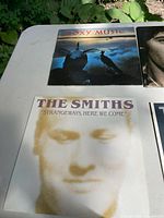 Overview of Avalon and Strangeways, Here We Come covers on white table outdoors