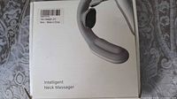Box of the intelligent neck massager showing picture and label