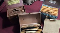 Image showing three different vintage filing boxes filled with 45 RPM records in paper sleeves. One box labeled 'Collector's Edition' is visible. Records are organized and stored upright.