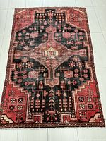 Full view of the Persian Hamadan rug showing overall medallion pattern and color scheme.