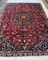 Full view of rug showing overall layout, field and border patterns