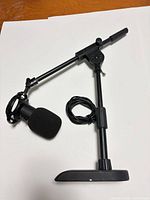 Full view of microphone assembled on boom stand with cable