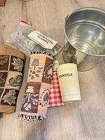 Overall lot showing bucket, utensil holder, runners, tablecloth, clamps