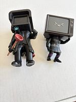 Both Skibidi Toilet figures side by side