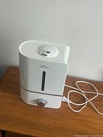 Front view showing Monad branding, water-level window and control dial