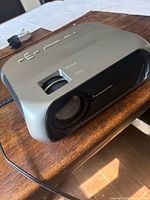 Top and front view of Monster Image Stream S5 projector showing lens and focus dial