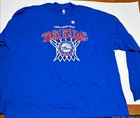 Full view of the blue long sleeve 76ers T-shirt