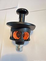 Full view of prism assembly showing housing, prisms, and mounting stud