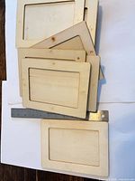 Stack of multiple birch plywood frames showing thickness and cut-out windows