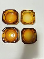 Top view of all four amber glass ashtrays
