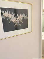 Framed floral print on wall showing full artwork and frame