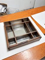 Front view showing 3x3 compartment layout and mirrored bottoms