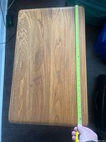 Top view showing wood grain and corner detail with tape measure indicating width