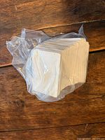 Stack of white blank plastic cards inside clear plastic bag