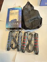 Retail box, black pouch and two sealed jump ropes