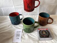 Four mugs and coaster box displayed together