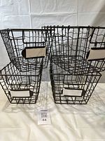 4 decorative wire baskets, 2 smaller and 2 larger, shown together