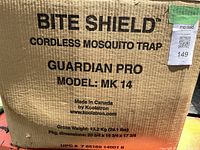Cardboard box with printed branding and model information of the Bite Shield cordless mosquito trap Guardian Pro model MK 14, made in Canada by Koolatron.