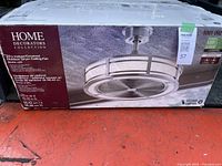 front of sealed product box showing Home Decorators Collection 23" Indoor/Covered Outdoor Drum Ceiling Fan Brette LED
