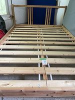 Full view of assembled double bed frame showing pine wooden slats and frame structure.