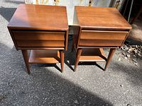 Pair of tapered-leg nightstands front view outdoors