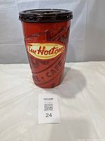 Front view of the Tim Hortons branded ceramic cookie jar with lid showing embossed logo and resealable lid.